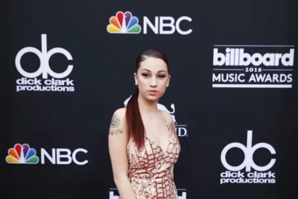 An image of Bhad Bhabie with a microphone in one hand and a laptop or phone in the other, accompanied by the text: "Get Your Free Pass to Bhad Bhabie's OnlyFans Page Now!"